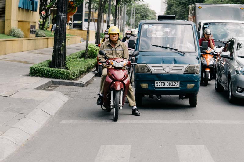 Scooters sitting in traffic in Saigon Vietnam