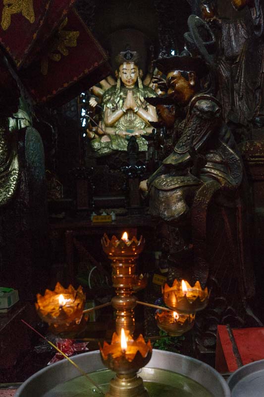 Alter with a figurine of a woman, praying in Saigon Vietnam