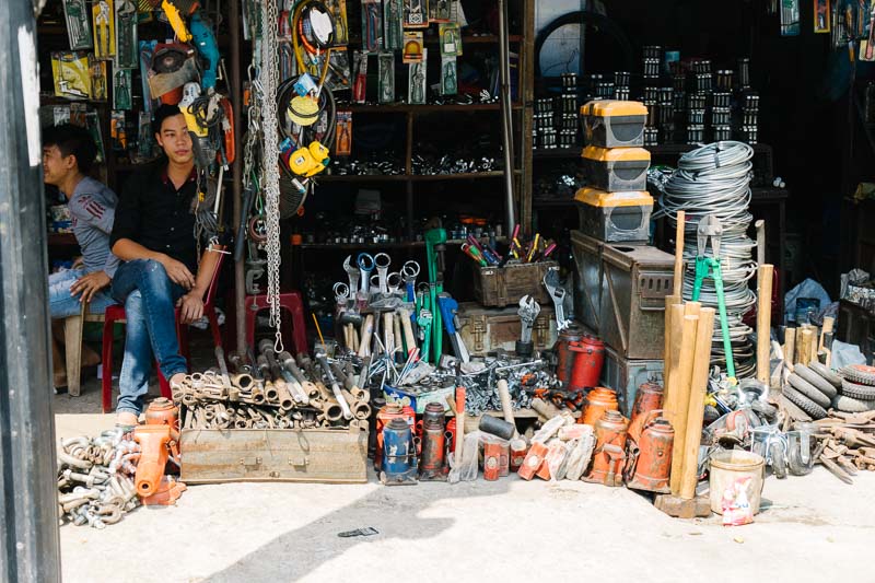 A picture of two young men at a shop selling tools in Saigon Vietnam