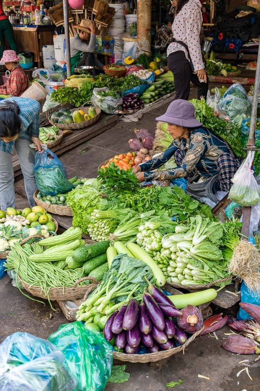 A woman at a vegetable stall at a market in Cambodia