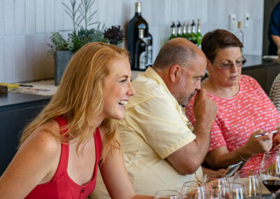 A beautiful young lady, laughing at a joke at a lunch at Silver Oak Wine